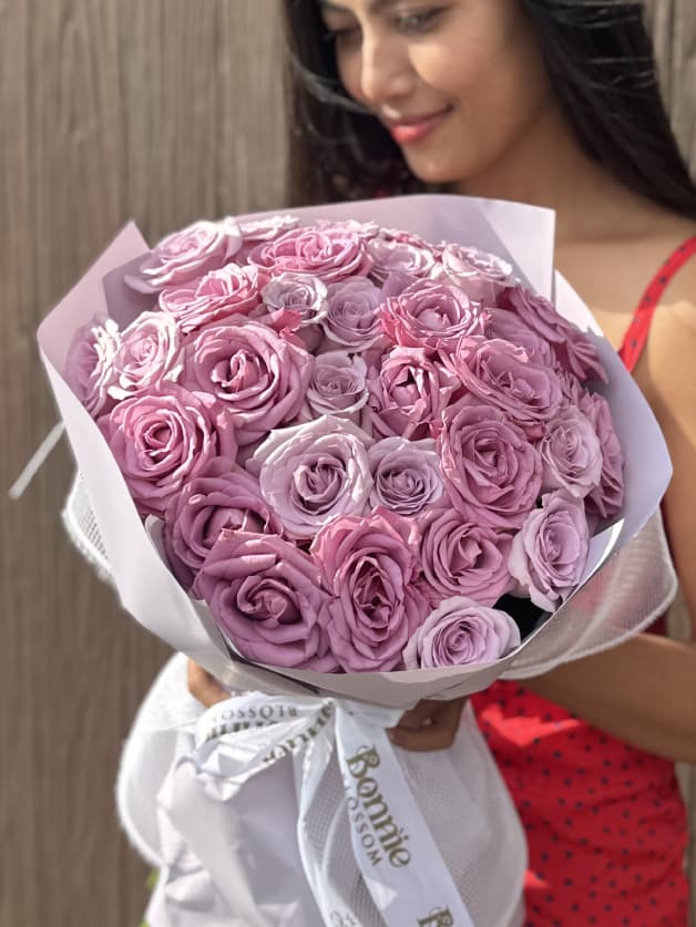A stunning bouquet of 31 purple Holland roses